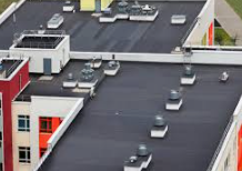 Aerial_view_of_a_flat_building_rooftop_with_air_conditioning_units_and_vents.

